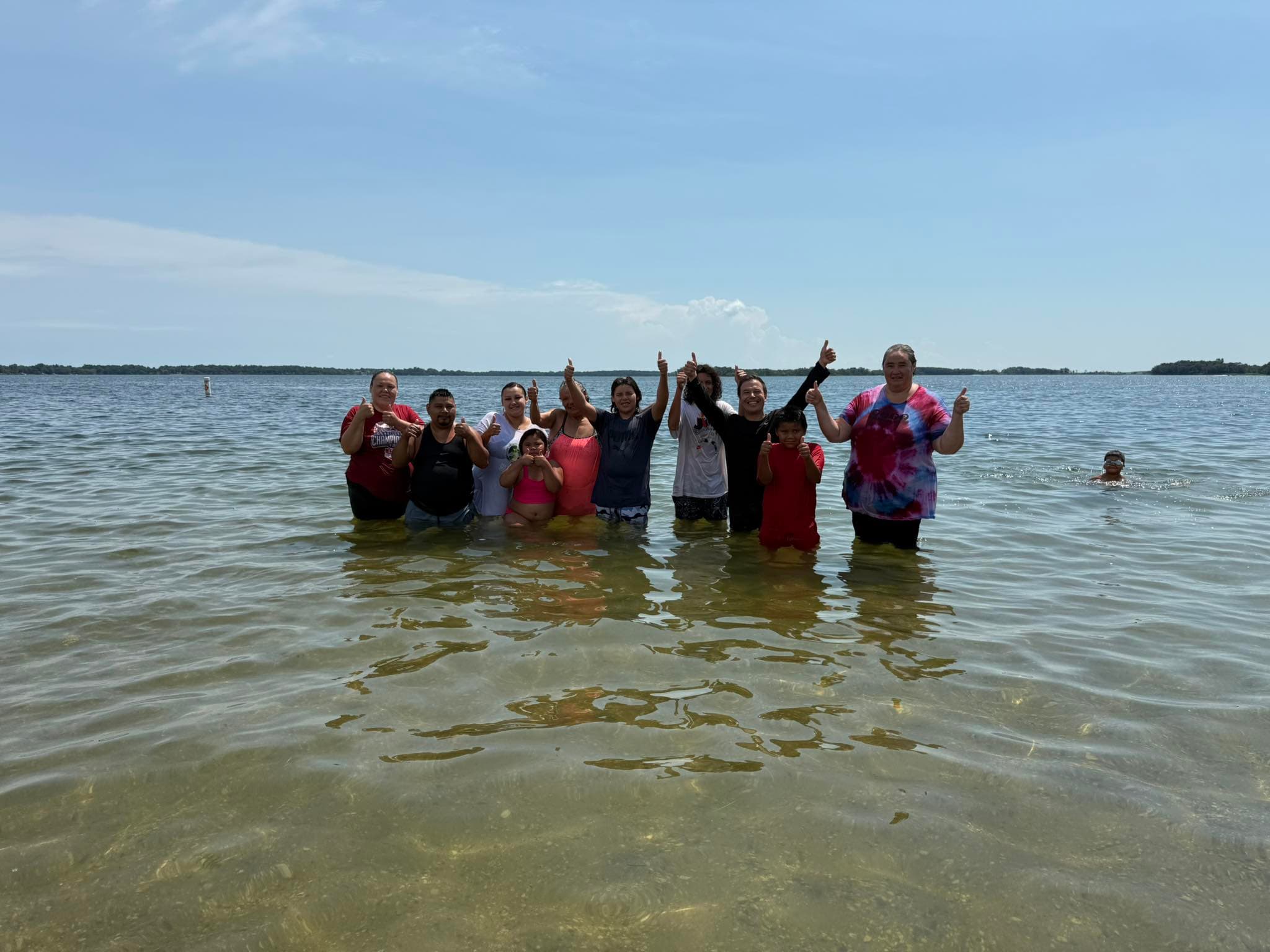 A group celebrating baptisms in a South Dakota lake